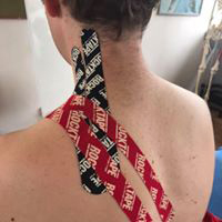 True Motion Sports Massage showing kinesio taping of left shoulder