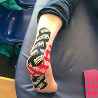 True Motion Sports Massage showing kinesio taping of right heel and ankle