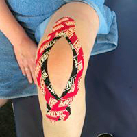 True Motion Sports Massage showing kinesio taping of knee