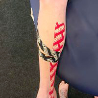True Motion Sports Massage showing kinesio taping of right leg